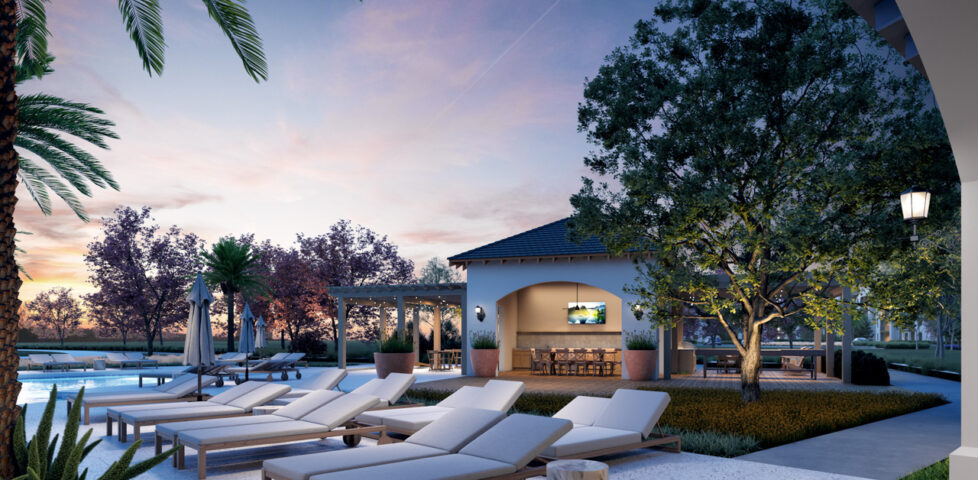lounge chairs next to a community outdoor dining space and pool at Soluna Apartments
